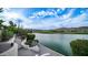 Scenic lake view showcases lush landscaping, serene waters, and distant mountain vistas against a blue sky at 16239 S 18Th Pl, Phoenix, AZ 85048