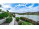 Beautiful lake view from the home with lush greenery, a serene lake, and mountains in the background at 16239 S 18Th Pl, Phoenix, AZ 85048