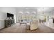 Spacious living room with lake views through large windows, showcasing a comfortable seating area and elegant décor at 16239 S 18Th Pl, Phoenix, AZ 85048