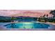 Beautiful backyard pool overlooking the golf course and lake at sunset at 16239 S 18Th Pl, Phoenix, AZ 85048