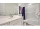 Bright bathroom featuring white cabinets, modern sink, and shower-tub combination at 16743 W Charlotte Dr, Surprise, AZ 85387