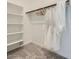 Bright walk-in closet features rod for hanging clothes and shelving for optimal storage and organization at 16743 W Charlotte Dr, Surprise, AZ 85387