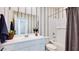 Bathroom view featuring a mirror, walk-in shower, tub, toilet and a white vanity at 16762 W Alameda Rd, Surprise, AZ 85387