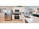 Modern kitchen with stainless steel appliances, white cabinets and a large countertop at 16762 W Alameda Rd, Surprise, AZ 85387