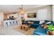 Inviting living room with a comfortable blue sectional sofa and open access to the kitchen at 16762 W Alameda Rd, Surprise, AZ 85387