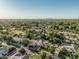 Wide real estate aerial view highlighting a sprawling residential neighborhood, mature trees and landscaping at 1758 E Carver Rd, Tempe, AZ 85284