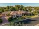 Aerial view of an expansive home with lush landscaping, mature trees, and a circular driveway at 1758 E Carver Rd, Tempe, AZ 85284