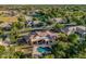 Estate home featuring a backyard oasis with a rock waterfall pool, lush landscaping, and mature shade trees at 1758 E Carver Rd, Tempe, AZ 85284