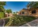 Expansive backyard with manicured lawn, mature trees, and a walkway leading to outdoor amenities at 1758 E Carver Rd, Tempe, AZ 85284