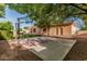 Backyard basketball court alongside a well-maintained, single-story home with neutral tones and mature landscaping at 1758 E Carver Rd, Tempe, AZ 85284