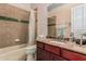 Full bathroom features a shower-tub combo and a vanity with a granite countertop at 1758 E Carver Rd, Tempe, AZ 85284