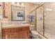 Cozy bathroom with tiled vanity, decorative mirror, and glass-enclosed shower at 1758 E Carver Rd, Tempe, AZ 85284