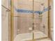 Bathroom with tiled shower-tub featuring a glass door and a wall-mounted shower head at 1758 E Carver Rd, Tempe, AZ 85284