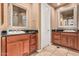 Spacious bathroom with dual wooden vanities, granite countertops, and decorative mirrors at 1758 E Carver Rd, Tempe, AZ 85284