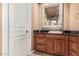 Elegant bathroom features a wooden vanity with granite countertop and decorative mirror at 1758 E Carver Rd, Tempe, AZ 85284