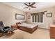 Bedroom with ceiling fan, neutral carpet, warm paint, and large window at 1758 E Carver Rd, Tempe, AZ 85284