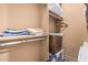 Bedroom closet with built in shelving and hanging rack at 1758 E Carver Rd, Tempe, AZ 85284