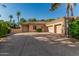 Well-maintained driveway leads to a three-car garage, surrounded by mature landscaping and a tile roof at 1758 E Carver Rd, Tempe, AZ 85284