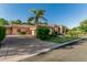 Beautiful home with well-manicured lawn, mature palm trees, desert landscaping and a spacious driveway at 1758 E Carver Rd, Tempe, AZ 85284