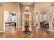 Spacious foyer with high ceilings, hardwood floors, and a decorative chandelier and entry door at 1758 E Carver Rd, Tempe, AZ 85284
