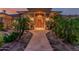 Charming front entrance with a custom wood door, mature desert landscaping and exterior stone accents at 1758 E Carver Rd, Tempe, AZ 85284