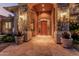 Inviting front entrance with a beautiful custom door, stone columns, and desert landscaping at 1758 E Carver Rd, Tempe, AZ 85284