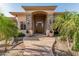 Stunning stone accented front entrance to the home with a beautiful wood door and lush landscaping at 1758 E Carver Rd, Tempe, AZ 85284