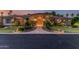 Inviting front entrance with a stone walkway, lush landscaping, and a beautiful custom wood door at 1758 E Carver Rd, Tempe, AZ 85284