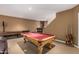 Basement game room featuring a pool table, shuffleboard table, and kitchenette at 1758 E Carver Rd, Tempe, AZ 85284
