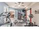 Home gym with exercise equipment that also provides access to another room in the house, likely a billiards room at 1758 E Carver Rd, Tempe, AZ 85284