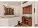 Hallway landing featuring a built-in desk with wooden cabinets and artistic decor on the wall at 1758 E Carver Rd, Tempe, AZ 85284