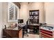 Functional home office with a large desk, shelving, and natural light, ideal for remote work at 1758 E Carver Rd, Tempe, AZ 85284