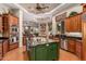Gourmet kitchen featuring stainless steel appliances, a green island, and a view into the living area at 1758 E Carver Rd, Tempe, AZ 85284