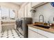 Well-equipped laundry room with modern washer and dryer, ample storage, and counter space at 1758 E Carver Rd, Tempe, AZ 85284