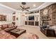 Spacious living room with stone fireplace, built-in shelves, and comfortable leather furniture at 1758 E Carver Rd, Tempe, AZ 85284