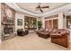 Comfortable living room features a stone fireplace, large windows, and a leather couch at 1758 E Carver Rd, Tempe, AZ 85284
