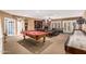 Large basement featuring a game room, brick fireplace, and living room area at 1758 E Carver Rd, Tempe, AZ 85284