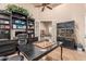 Spacious office with a large desk, bookshelves, and a view into a cozy living room at 1758 E Carver Rd, Tempe, AZ 85284
