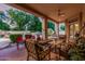 Covered patio with comfortable seating, overlooking the pool and lush backyard, ideal for outdoor gatherings at 1758 E Carver Rd, Tempe, AZ 85284