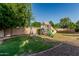 Backyard with a playground set, offering a fun and engaging space for children to play outdoors at 1758 E Carver Rd, Tempe, AZ 85284
