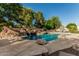 Resort-style pool with a rock waterfall feature, diving board, and lounge area for relaxation at 1758 E Carver Rd, Tempe, AZ 85284