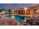 Backyard pool with rock accents and covered patio seating area at 1758 E Carver Rd, Tempe, AZ 85284