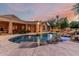 Beautiful pool area with rock features and a slide, creating a fun and relaxing backyard oasis at 1758 E Carver Rd, Tempe, AZ 85284