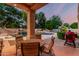 Inviting covered outdoor seating area with a view of the pool and rock waterfall, perfect for relaxing and entertaining at 1758 E Carver Rd, Tempe, AZ 85284