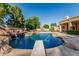 Resort-style pool featuring a rock waterfall, diving board, and ample lounging space for outdoor enjoyment at 1758 E Carver Rd, Tempe, AZ 85284