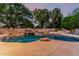 Stunning pool area with rock waterfall feature and ample space for lounging, perfect for summer relaxation at 1758 E Carver Rd, Tempe, AZ 85284