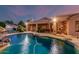 Backyard pool with slide, rock accents, and covered patio at 1758 E Carver Rd, Tempe, AZ 85284