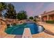 Backyard pool featuring a waterfall, diving board, and lush landscaping at 1758 E Carver Rd, Tempe, AZ 85284