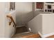 Carpeted staircase with wooden handrail in neutral tones at 1758 E Carver Rd, Tempe, AZ 85284