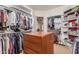 Spacious walk-in closet with center island, ample shelving, and hanging storage at 1758 E Carver Rd, Tempe, AZ 85284